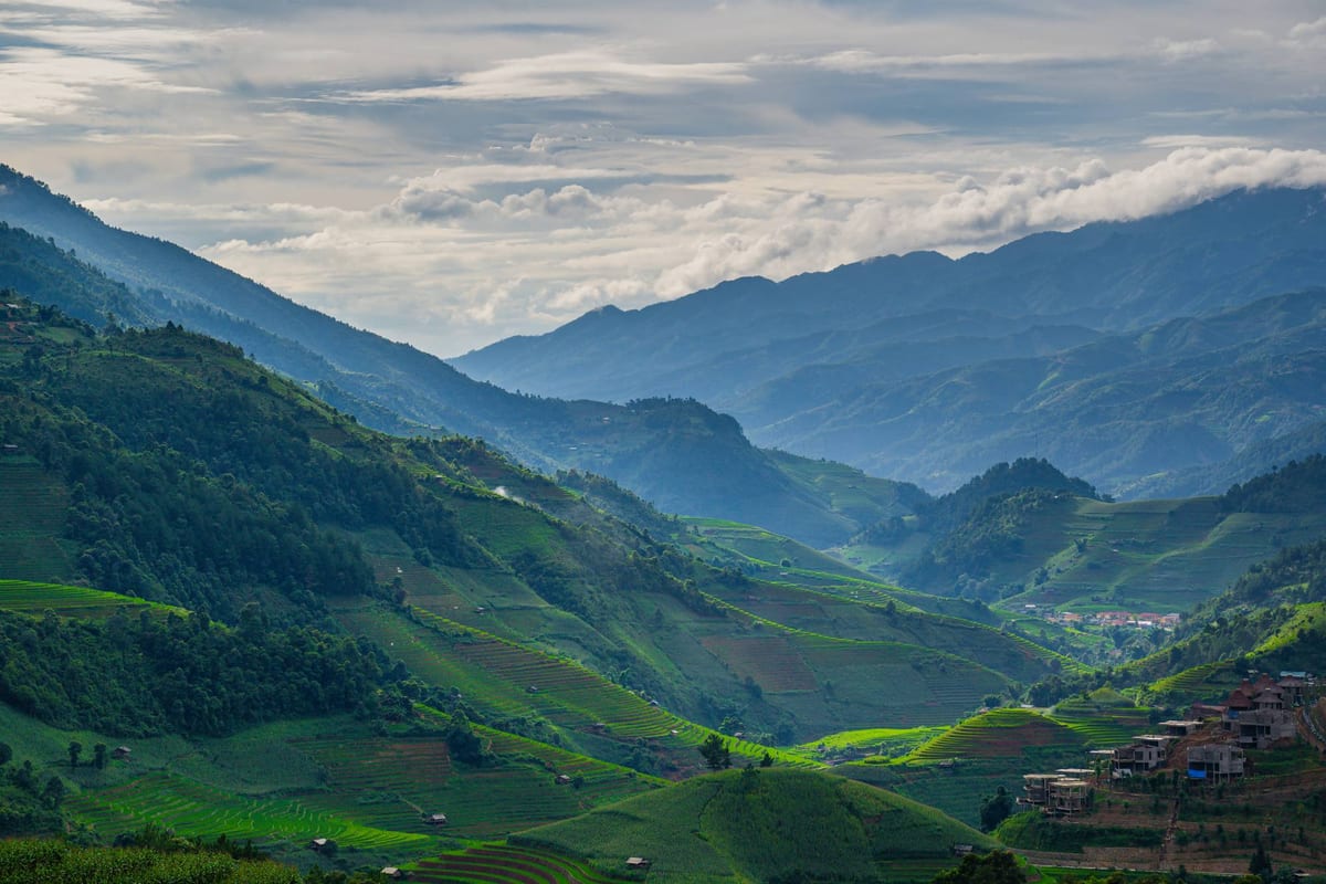 A misty valley of terraced rice fields surrounded by mountains